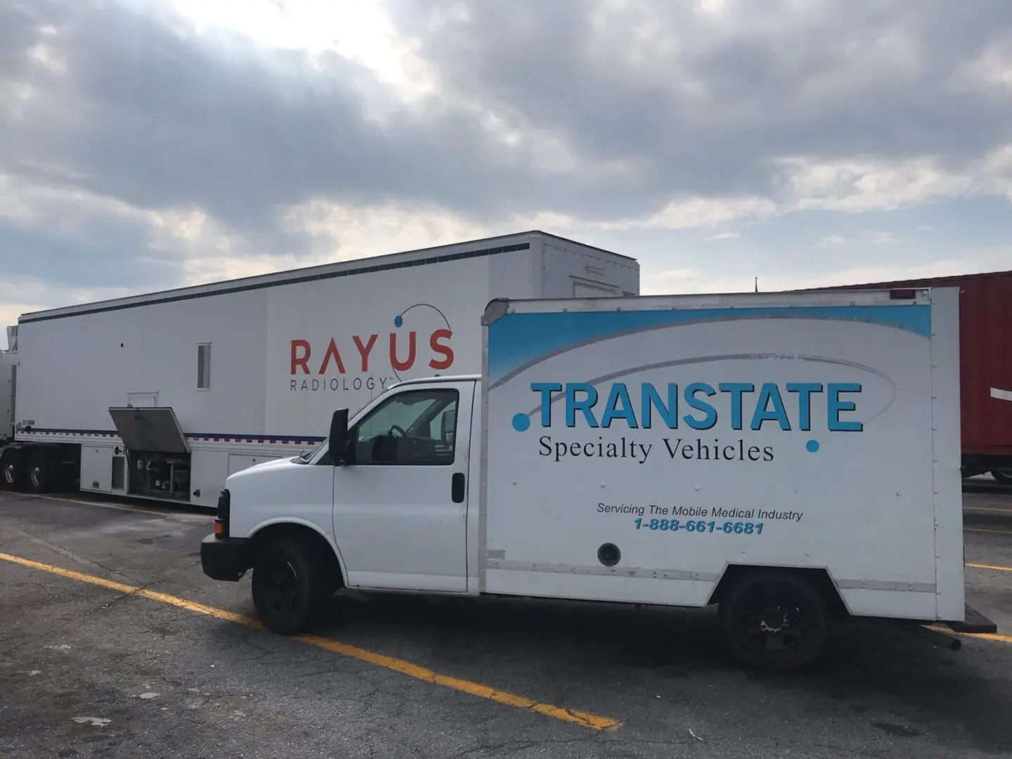 A white truck with the name " rayus " on it.