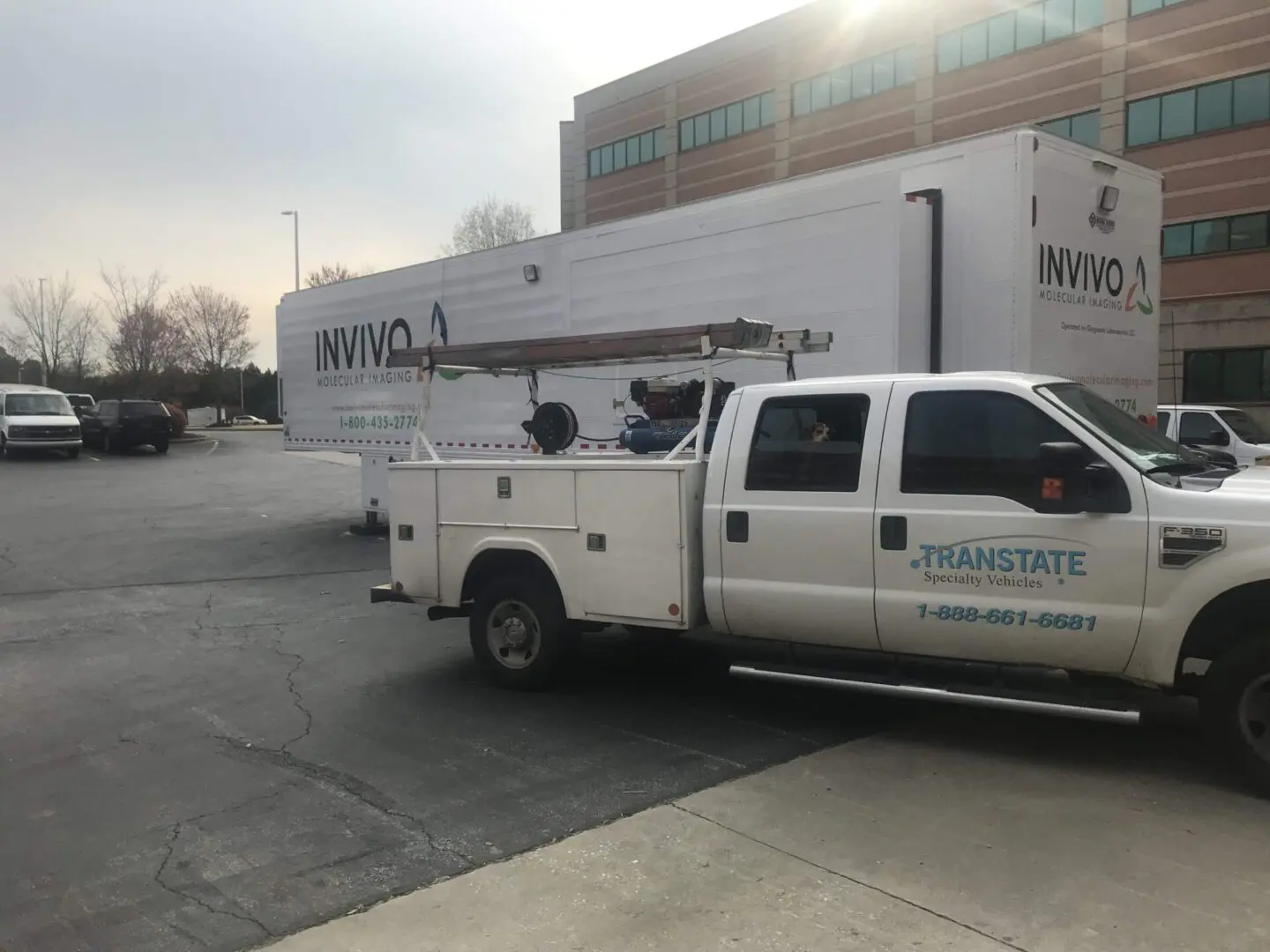 A white truck with a large trailer in the back.