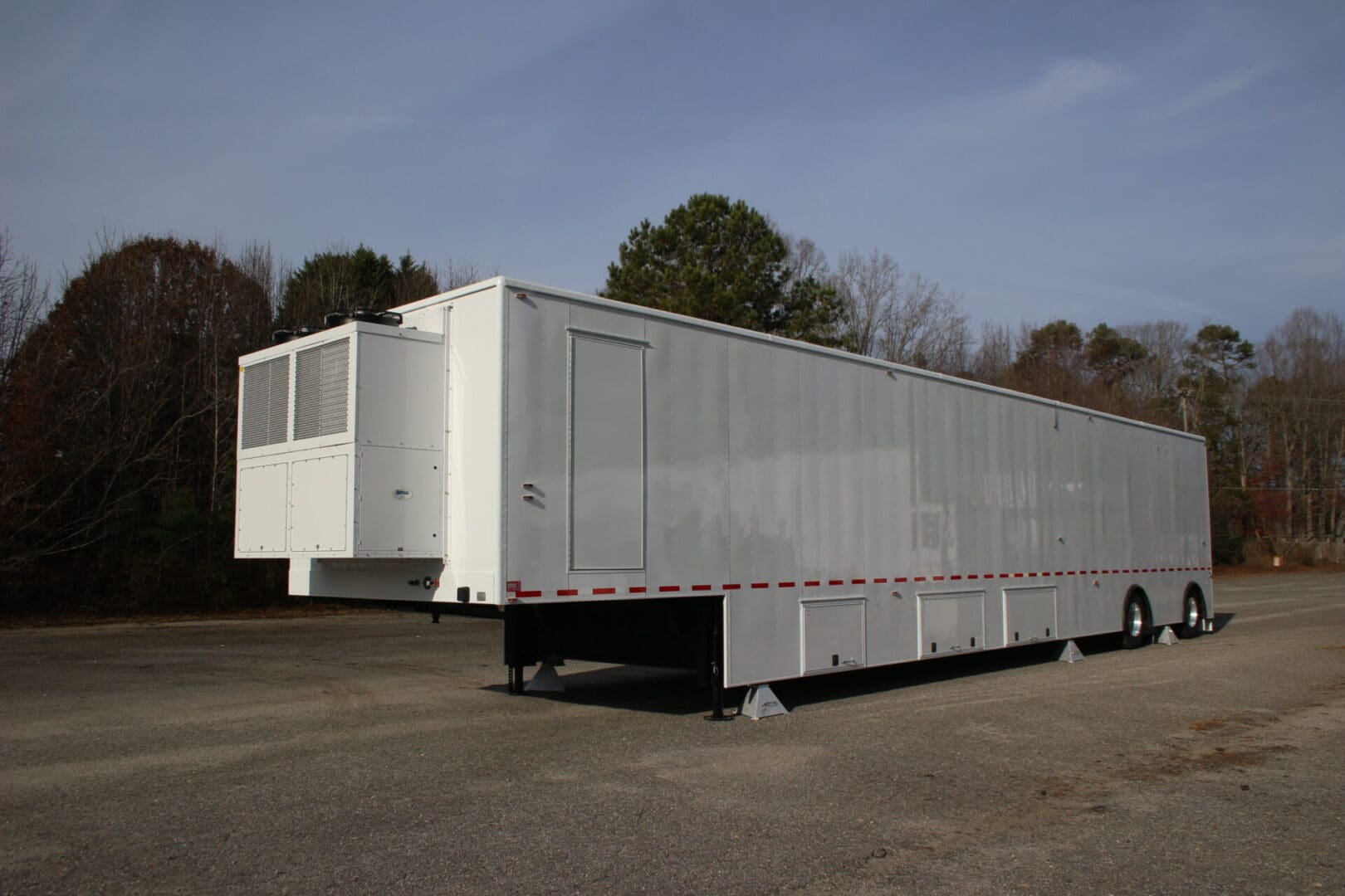 A large trailer parked in the middle of a lot.